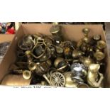 Two boxes of assorted brass and other metal wares to include candlesticks, bells, chargers, figures,