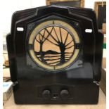 An Art Deco Ekco bakelite radio with pierced tree decoration to the front grill bears label verso