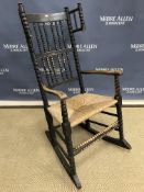 A black stained ash and beech rocking chair in the style of Ernest Gimson for Robert Weir Schultz