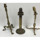 Two circa 1900 brass train / ship lamps, the pedestals raised on tripod feet,