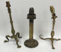 Two circa 1900 brass train / ship lamps, the pedestals raised on tripod feet,