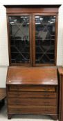 An Edwardian mahogany and satinwood banded bureau bookcase in the Sheraton Revival taste,