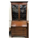 An Edwardian mahogany and satinwood banded bureau bookcase in the Sheraton Revival taste,