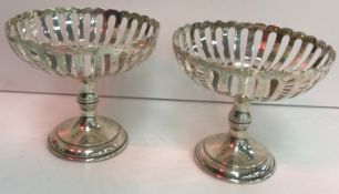 A pair of Edwardian silver pedestal dishes with pierced decoration raised on circular bases (by