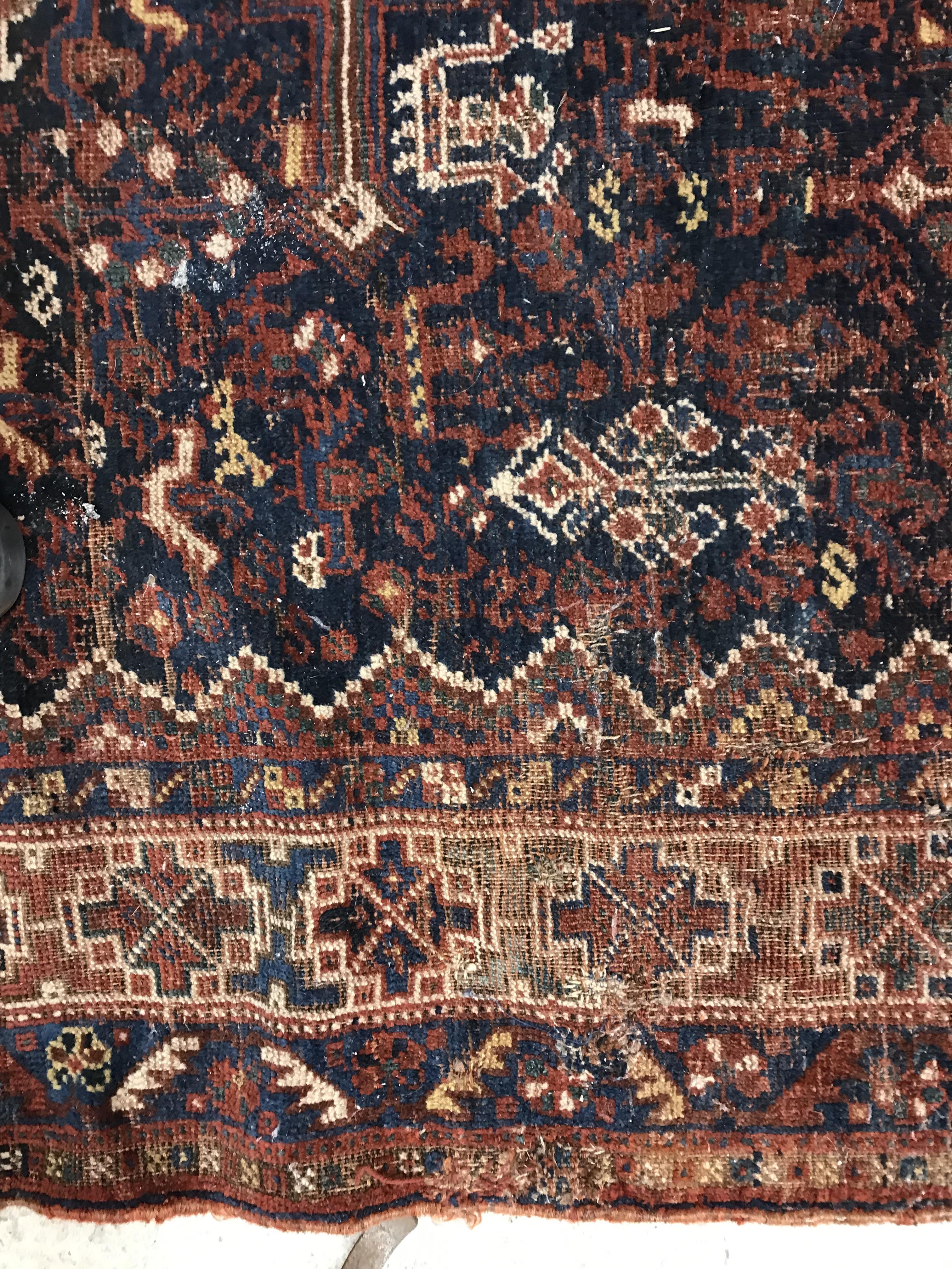A Persian carpet, the central panel set with repeating medallions on a dark blue ground, - Image 26 of 93