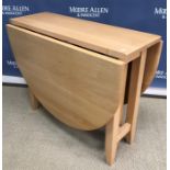 A modern hardwood coffee table, the plain top above three drawers, raised on squat square legs,