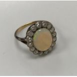 A yellow and white metal opal and diamond set dress cluster ring,