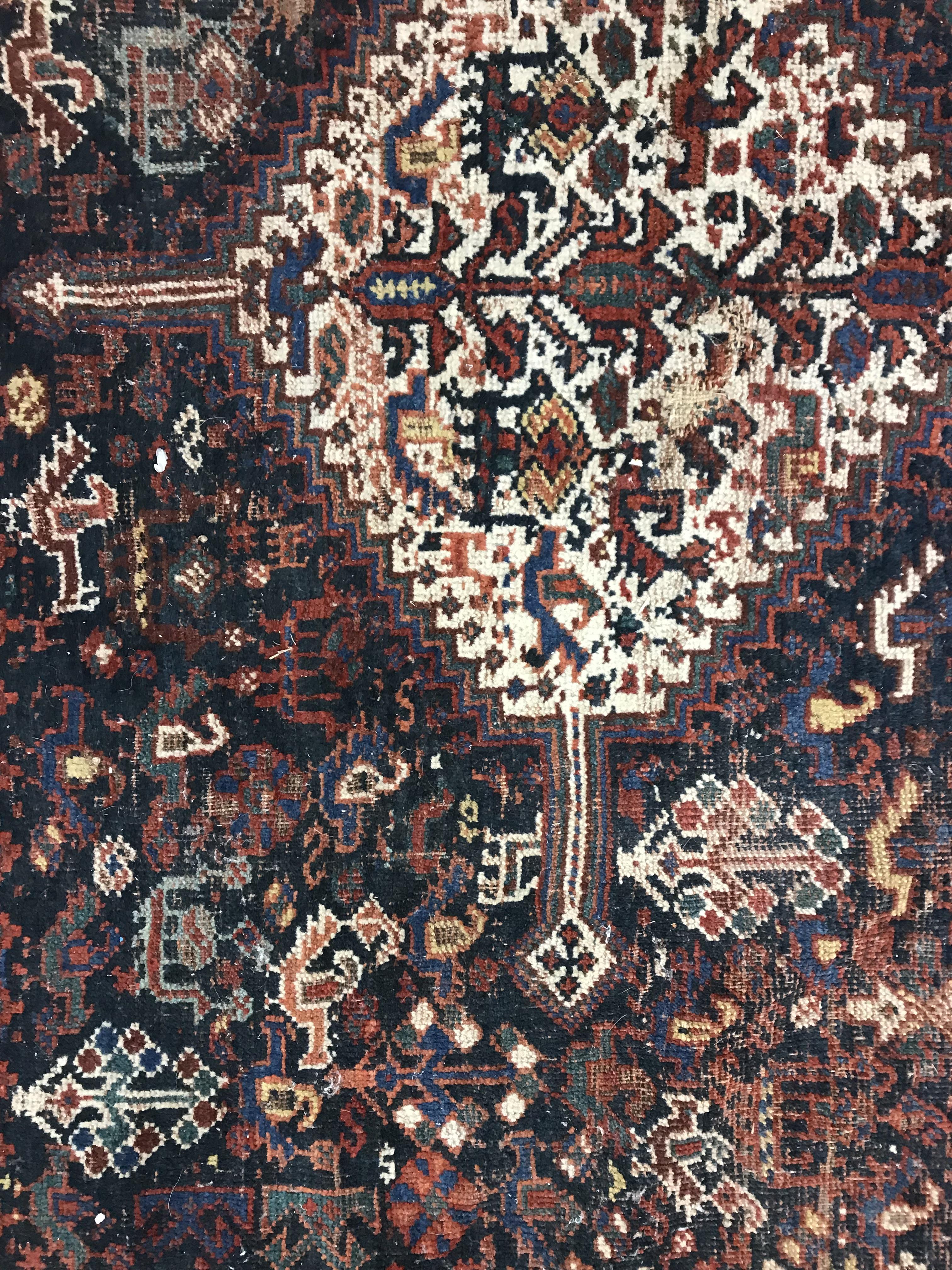 A Persian carpet, the central panel set with repeating medallions on a dark blue ground, - Image 33 of 93