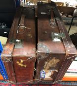 A vintage brown leather suitcase initialled "ASH" to front together with a further vintage leather