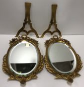 A pair of 19th Century gilt metal easel mirrors of oval form with ribbon and scrolling foliate