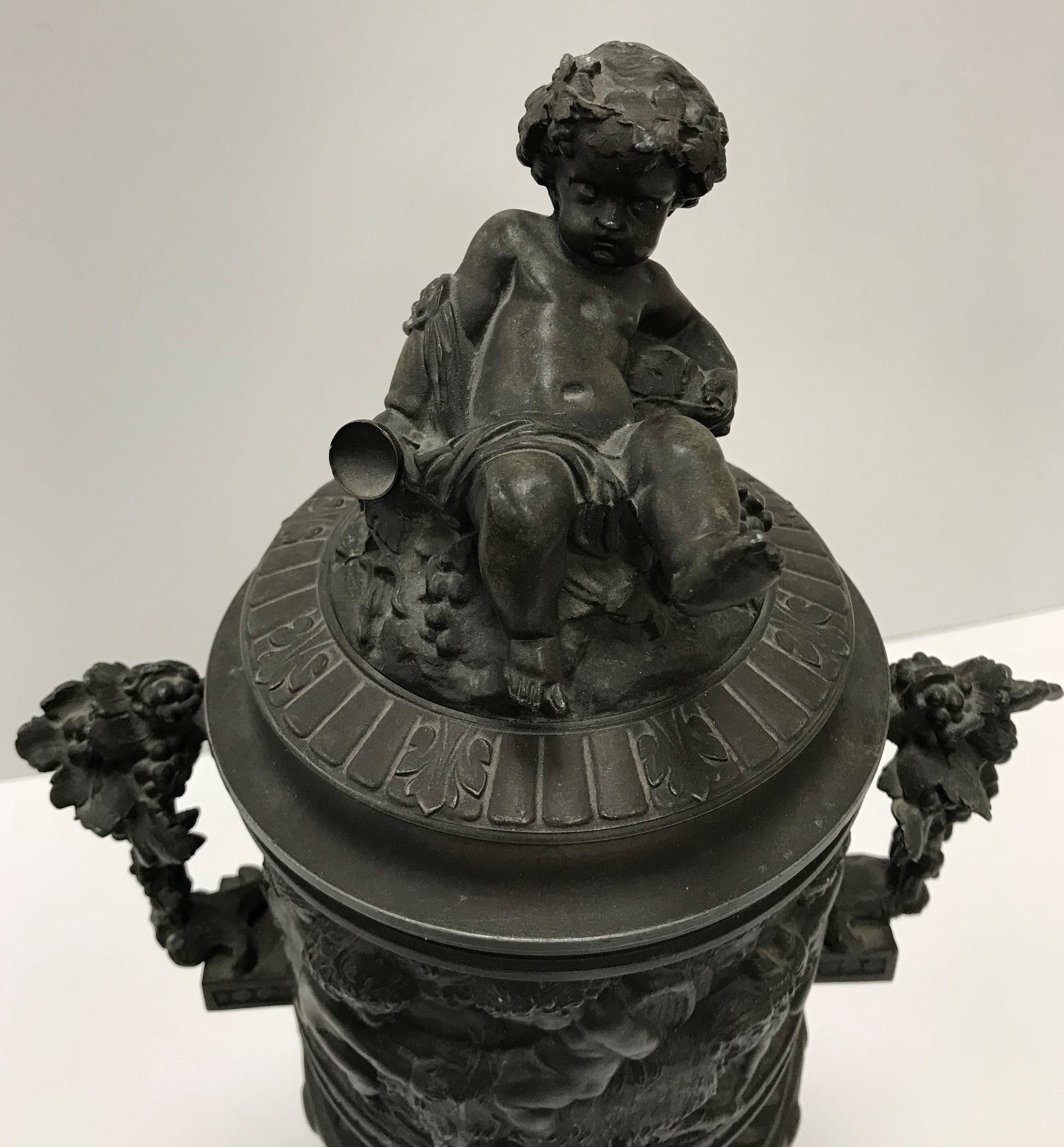 A cast metal bronzed urn with bacchanalian cherub and ram decoration, - Image 2 of 2