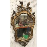 A 19th Century gilt and gesso framed wall mirror of shaped form with scrolling acanthus leaf