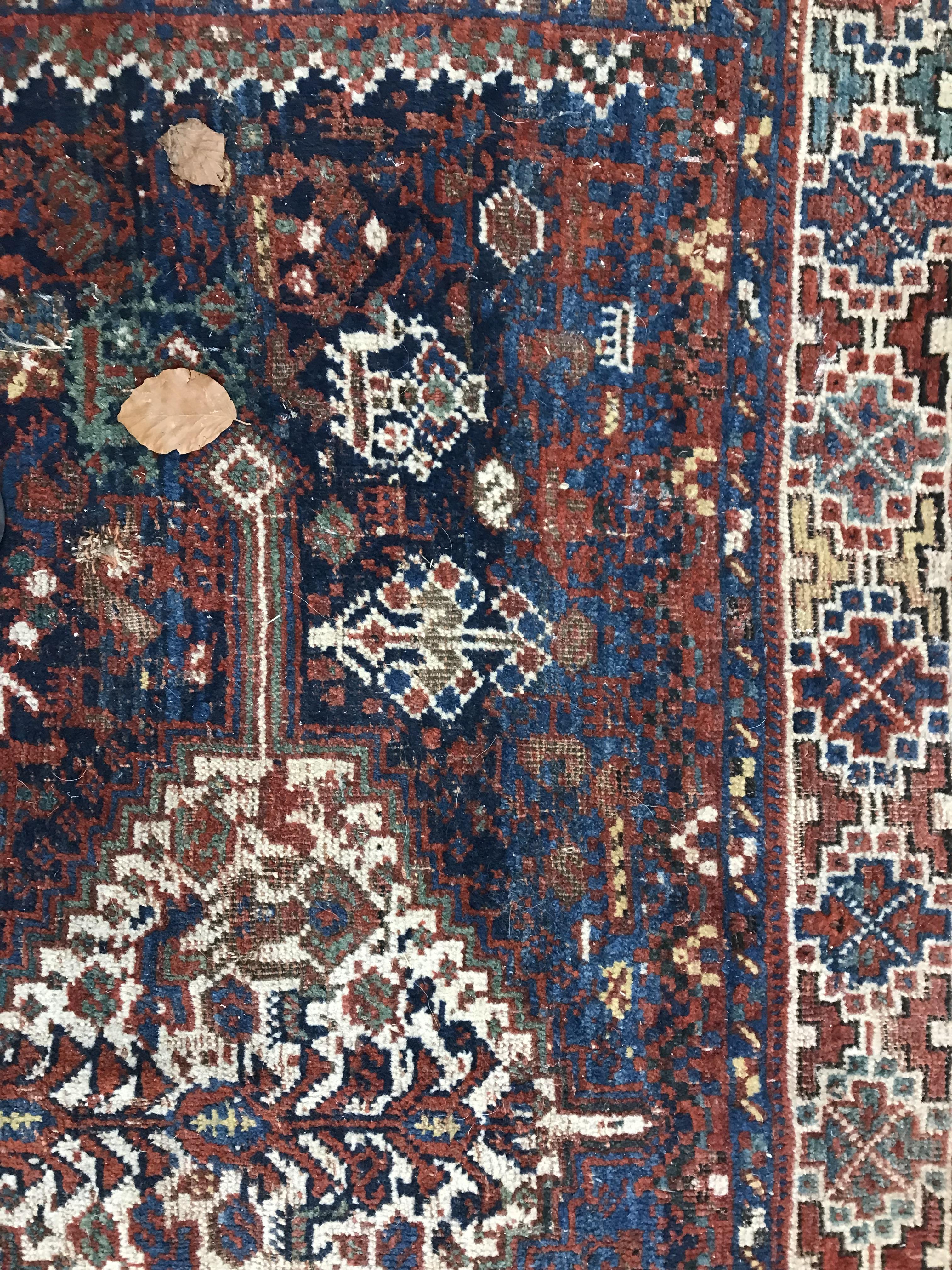 A Persian carpet, the central panel set with repeating medallions on a dark blue ground, - Image 16 of 93