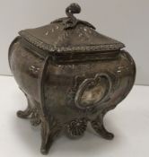 A Victorian silver sugar box of square bombé form in the Rococo taste (by Daniel and John Wellby,