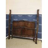 A 20th Century French walnut bedstead in the Louis XV provincial manner,