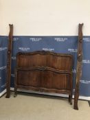 A 20th Century French walnut bedstead in the Louis XV provincial manner,