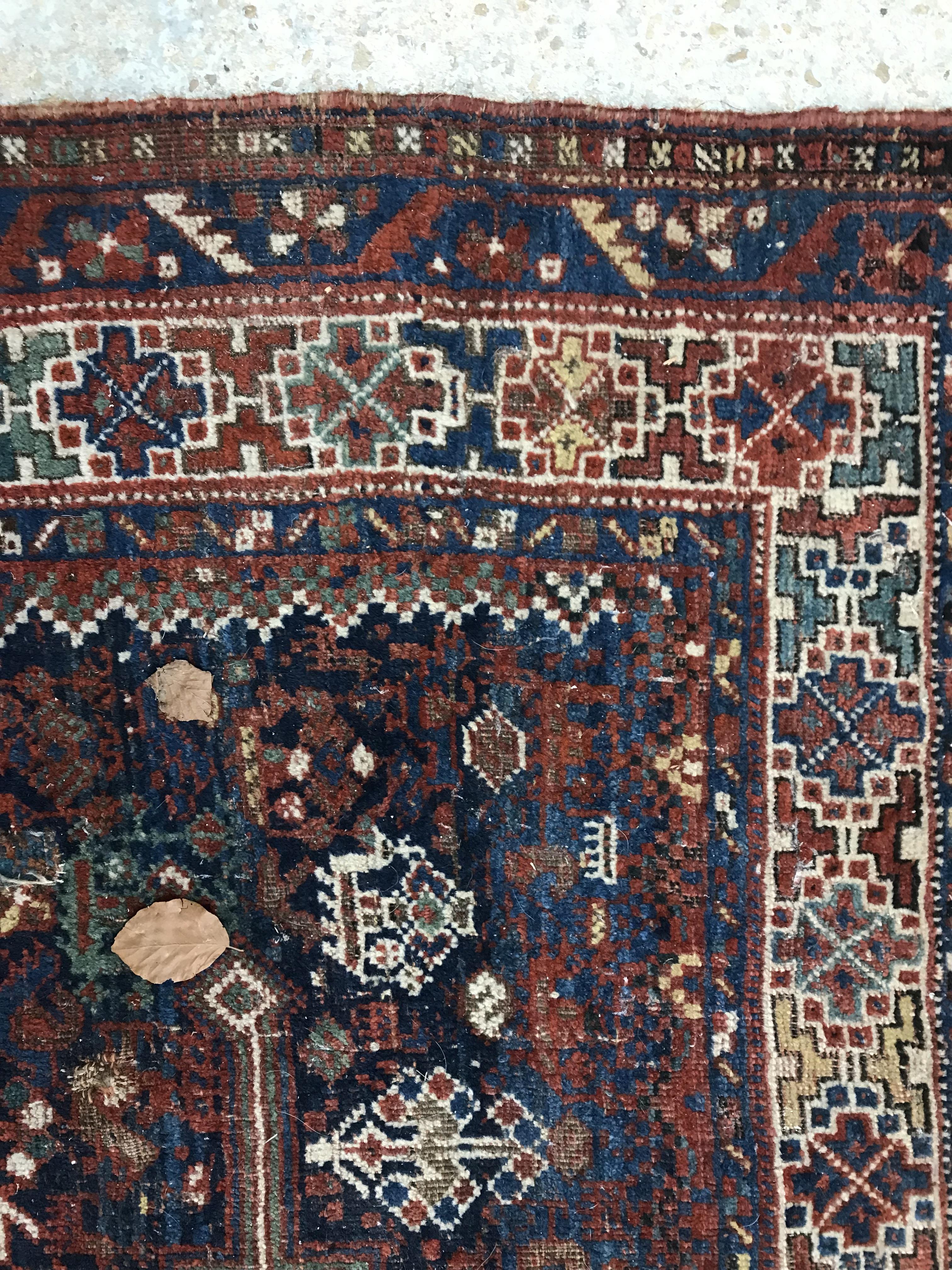 A Persian carpet, the central panel set with repeating medallions on a dark blue ground, - Image 15 of 93