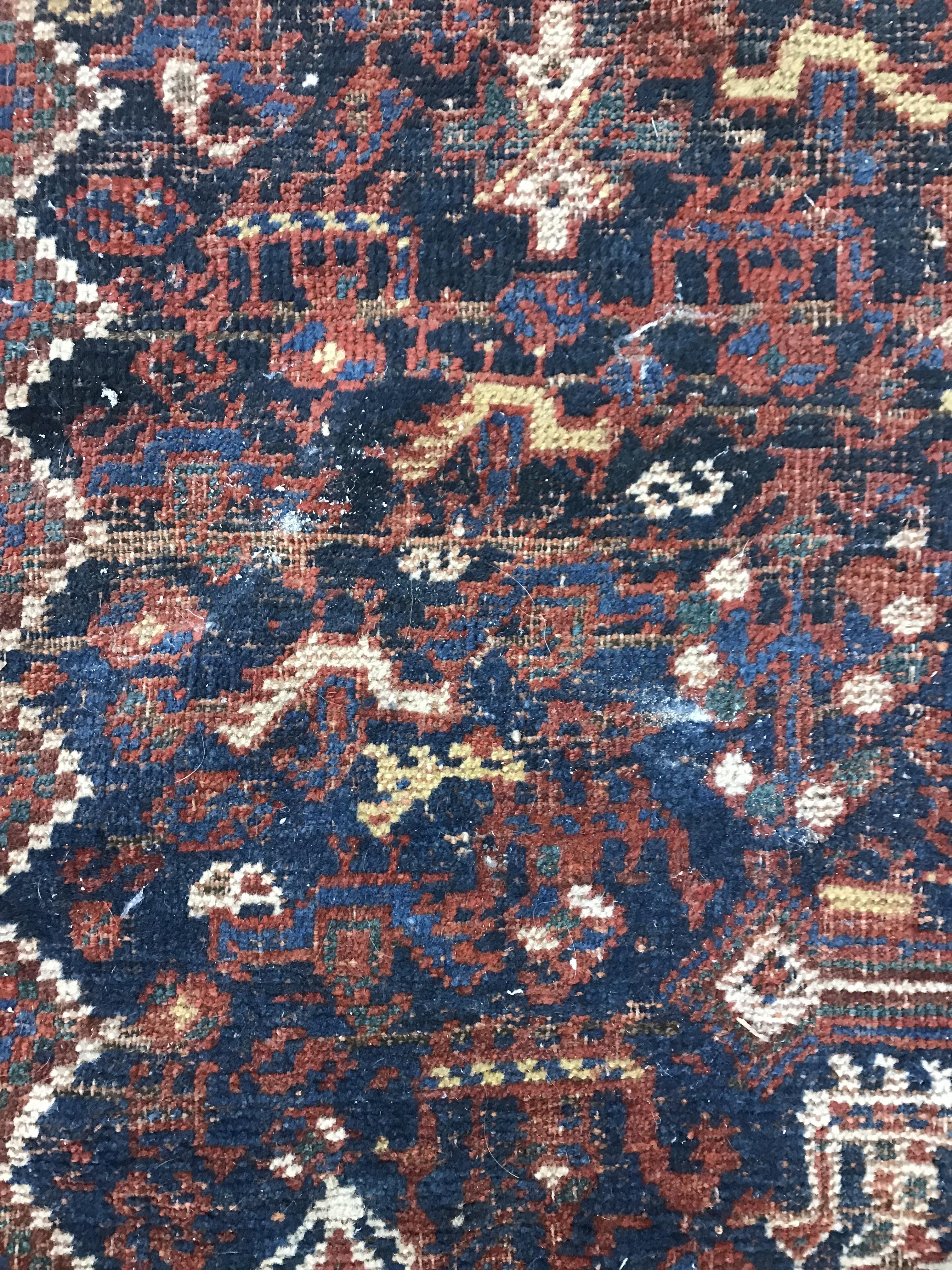 A Persian carpet, the central panel set with repeating medallions on a dark blue ground, - Image 9 of 93