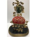 A French 19th Century wedding display with mirror and foliate decoration on a red velvet cushion