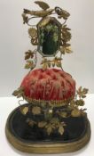 A French 19th Century wedding display with mirror and foliate decoration on a red velvet cushion