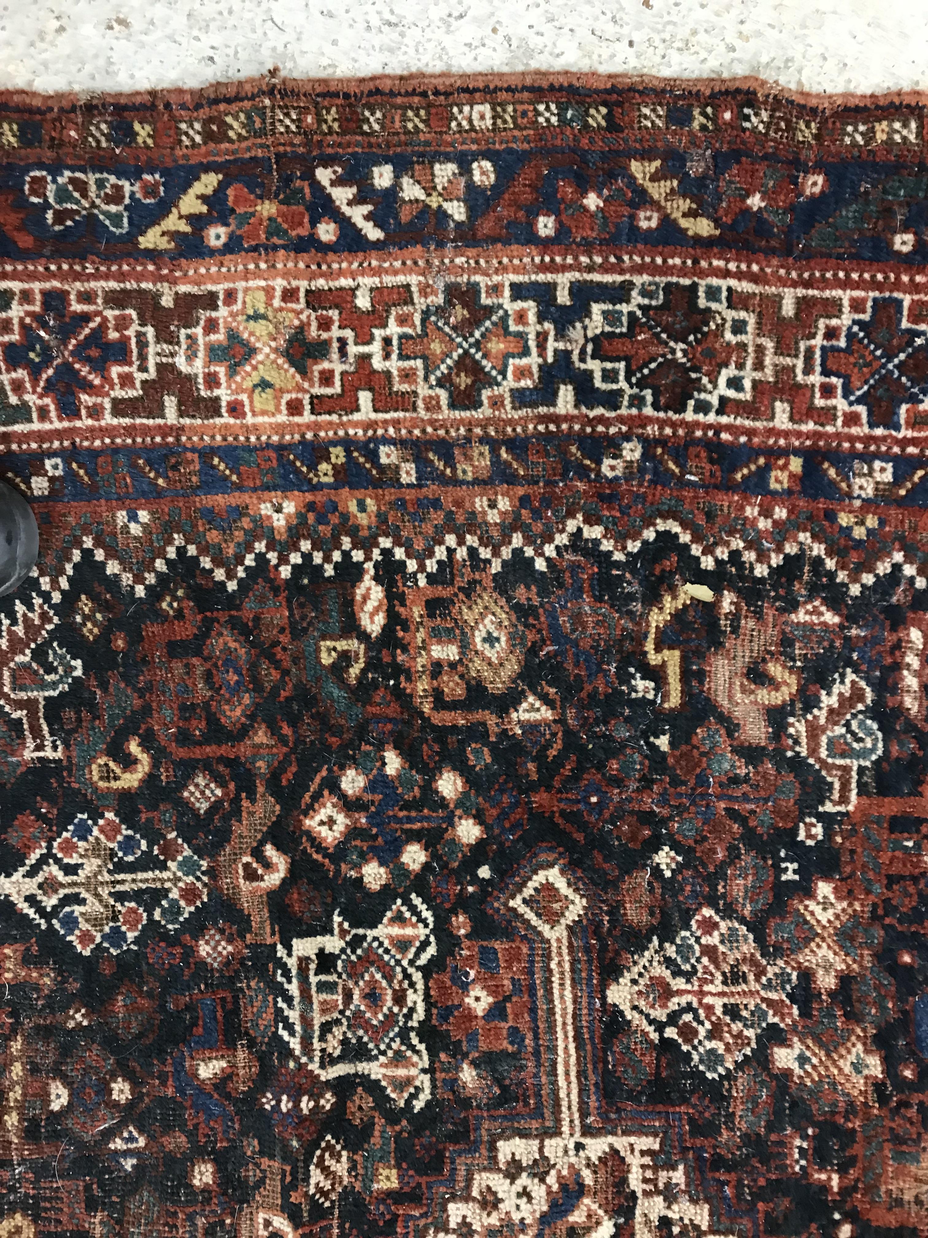 A Persian carpet, the central panel set with repeating medallions on a dark blue ground, - Image 31 of 93