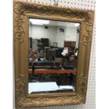 A modern gilt framed convex mirror in the Regency style,