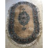 A Belouch rug, the central panel set with floral decorated medallion on a plain faun ground,