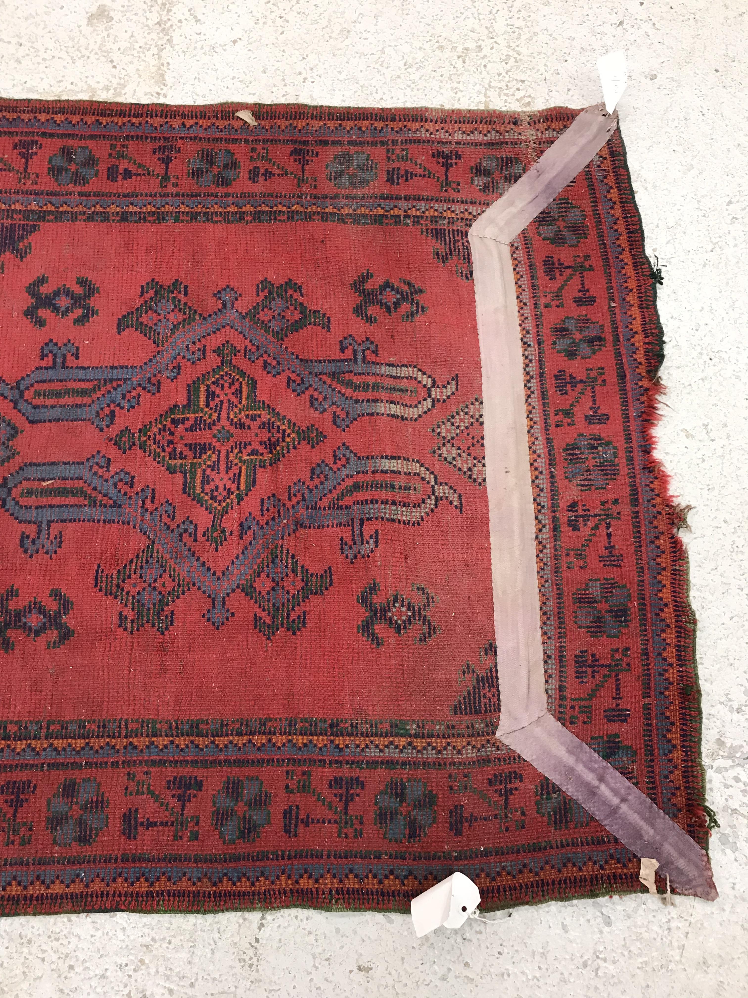 A Donegal style runner, the central panel set with repeating geometric design on a red ground, - Image 12 of 18