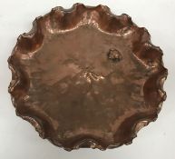 A collection of four early 20th Century and later circular copper trays comprising a Newylyn tray