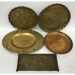 A collection of five Arts & Crafts brass trays with embossed decoration,