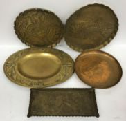 A collection of five Arts & Crafts brass trays with embossed decoration,