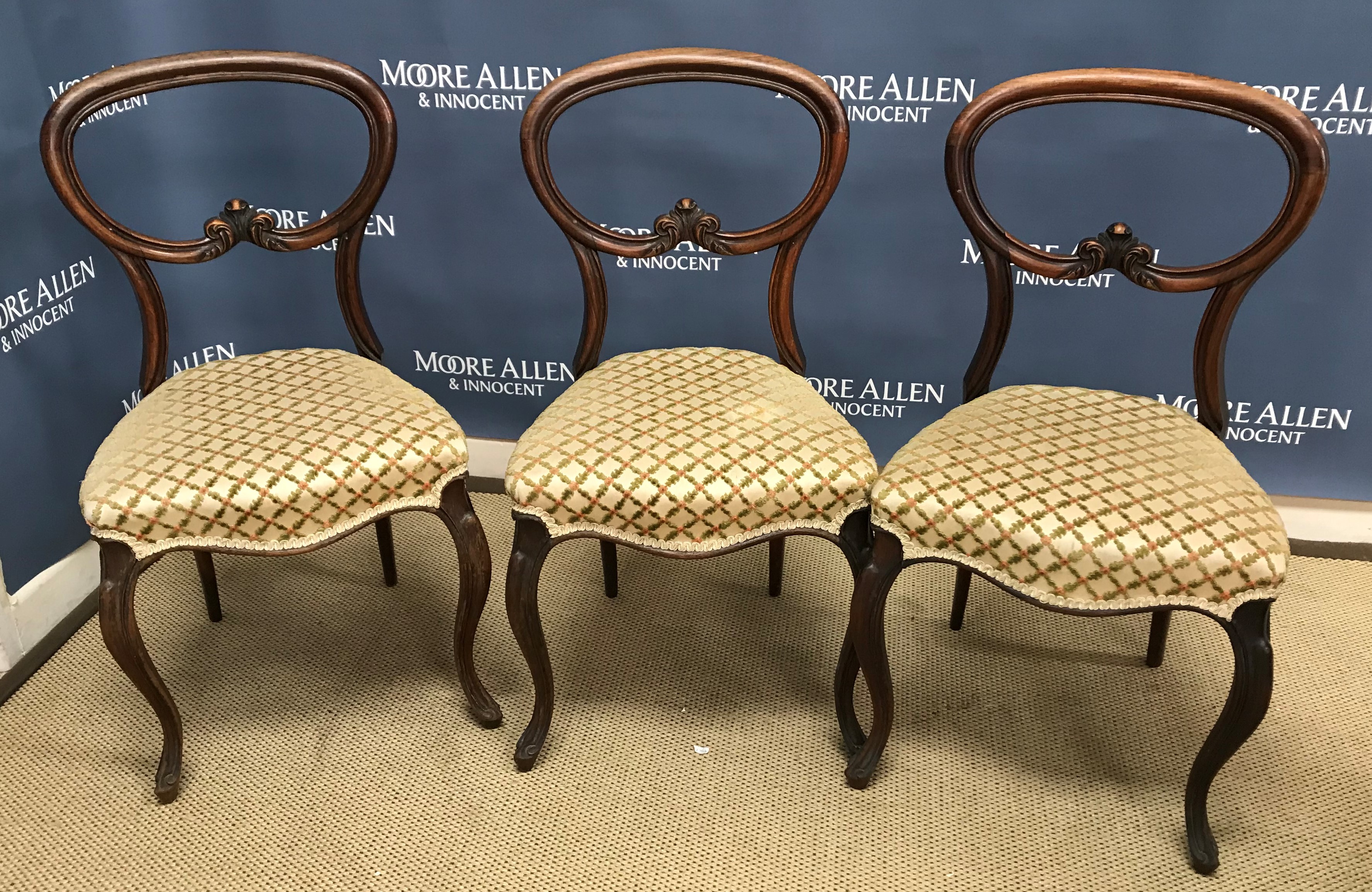 A set of three Victorian rosewood balloon back dining chairs