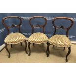 A set of three Victorian rosewood balloon back dining chairs