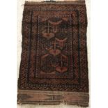 A Belouch rug, the central panel set with geometric design on a red ground,