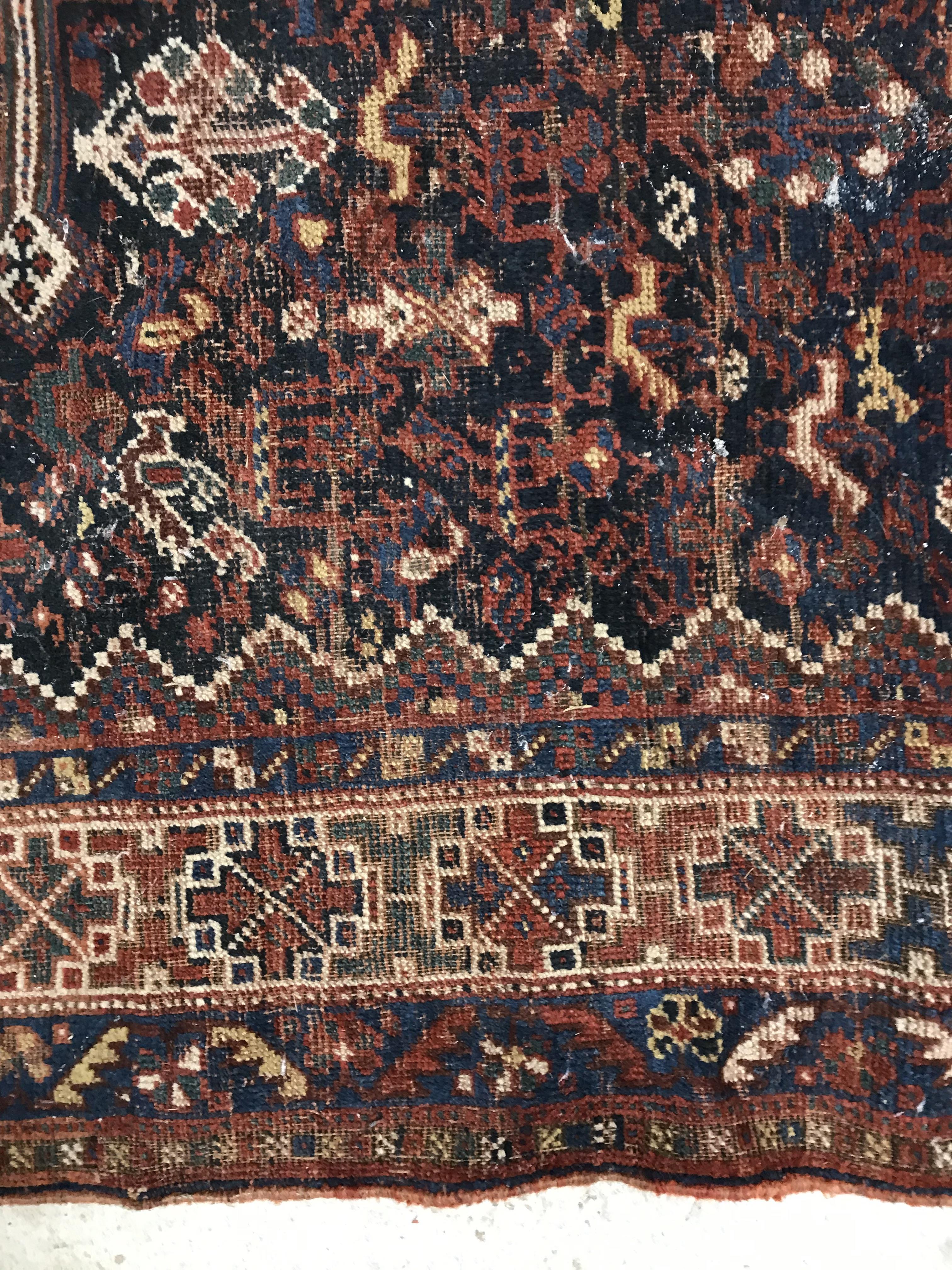 A Persian carpet, the central panel set with repeating medallions on a dark blue ground, - Image 27 of 93