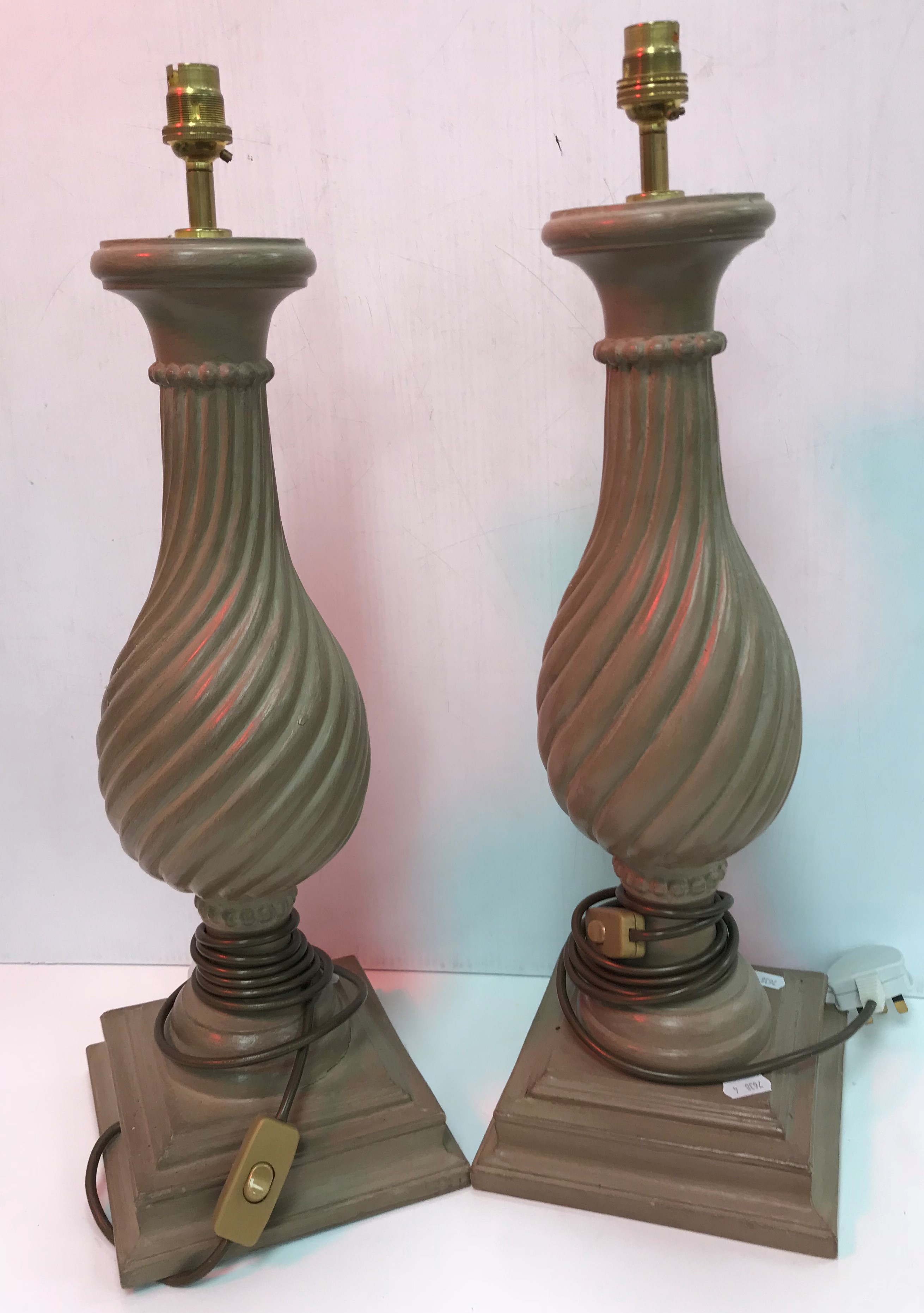 A pair of Oka painted writhen turned baluster table lamps raised on square stepped bases 50 cm high
