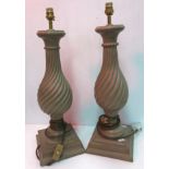 A pair of Oka painted writhen turned baluster table lamps raised on square stepped bases 50 cm high