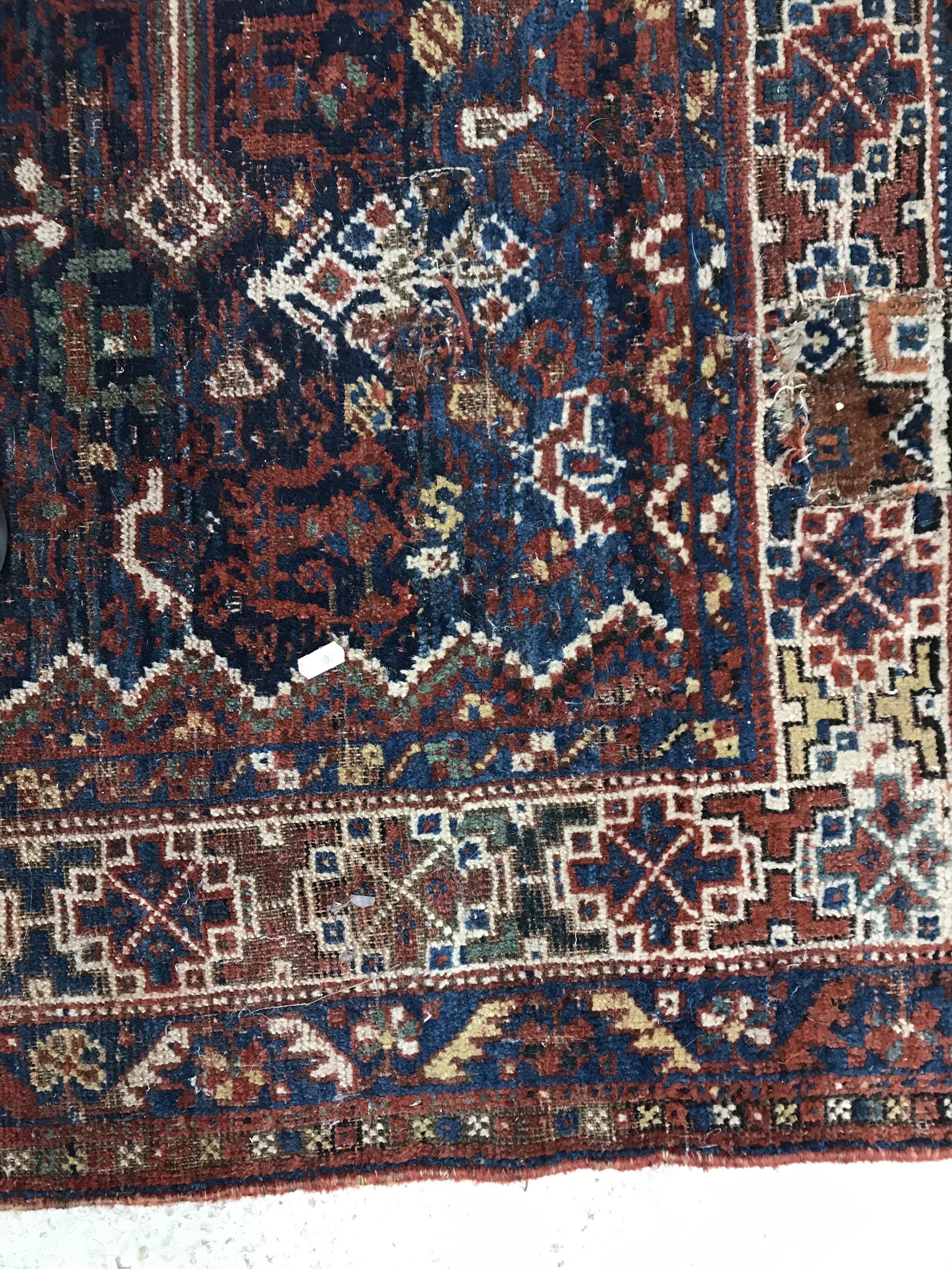 A Persian carpet, the central panel set with repeating medallions on a dark blue ground, - Image 18 of 93