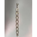 A 9 carat gold horseshoe bracelet with unusual clasp mechanism (Birmingham 1993) 13.