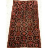 A Beshir rug, the central panel set with repeating geometric designs on a dark black ground,