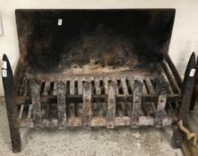 A cast iron fire basket with integral back of plain form,