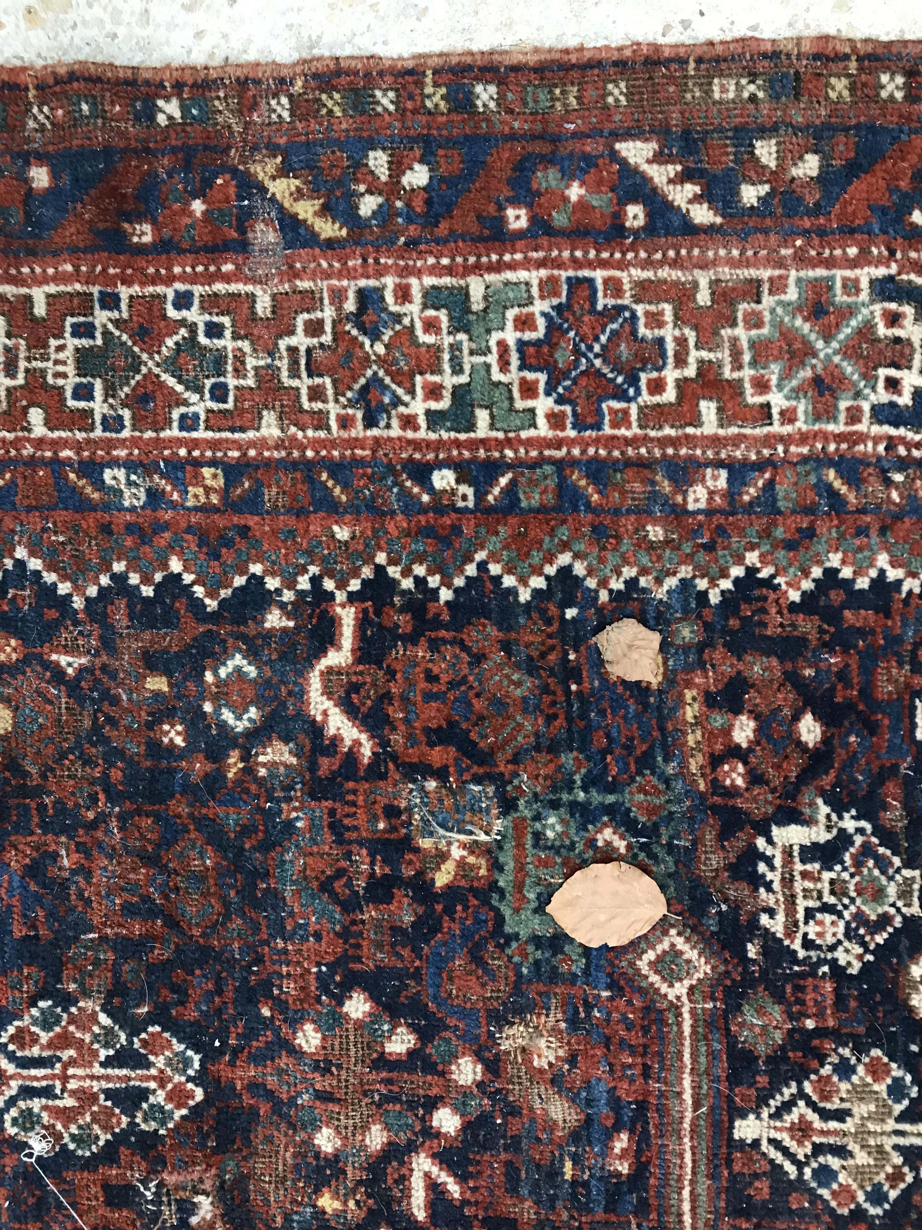 A Persian carpet, the central panel set with repeating medallions on a dark blue ground, - Image 22 of 93