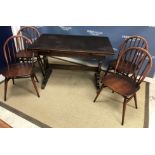 An Ercol elm rectangular extending dining table on end trestle supports united by a centre