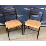 A set of four Swedish Gemla teak framed ladder back dining chairs with leather upholstered seats on