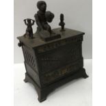 A 19th Century painted cast iron "Organ bank" money box depicting a monkey and dancing figures upon