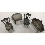 A suite of miniature silver furniture in the Rococo style comprising scroll arm settee,