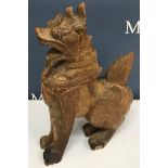 A carved Burmese figure of a dragon crouching on hind legs 37 cm high