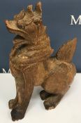 A carved Burmese figure of a dragon crouching on hind legs 37 cm high
