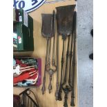 Two Georgian steel fire iron sets, each comprising poker, shovel and tongs,