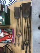 Two Georgian steel fire iron sets, each comprising poker, shovel and tongs,